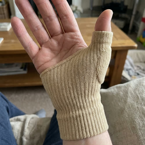 Customer photo of the Sorlelle wrap on hand in a kitchen, watch and ring visible